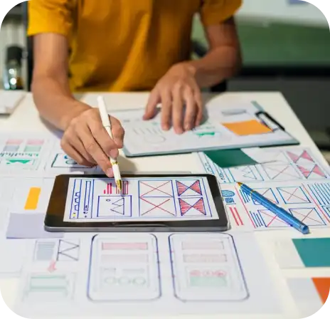 About Us a person using a pen on a tablet